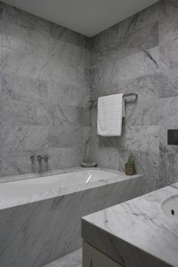 marble bathtub and shower wall